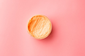 cosmetic for body, face, hair. face cream in a jar. hair mask. skin care. on a pink background. selective focus.