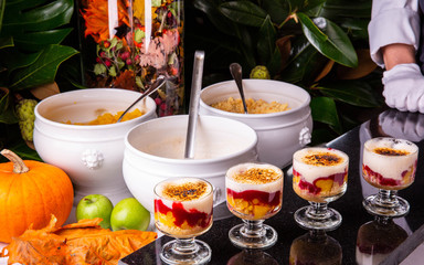 Giving of a berry dessert on a black marble background