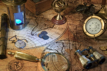 Old Zodiac globe,astrological.Vintage map,old coins.Retro ship lantern,binoculars,sextant.Antique compass.Candlestick,watch and magnifier Travel and marine engraving background. Treasure hood concept.