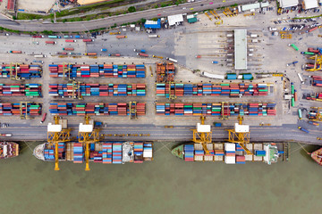 Flying above colorful pattern of Logistics and transportation in Laem Chabang International Terminal thailand / Aerial view of Container Cargo ship - Commercial port and Cargo import/export - obrazy, fototapety, plakaty