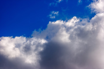 Naklejka na ściany i meble dense and great white clouds on a beautiful summer blue sky