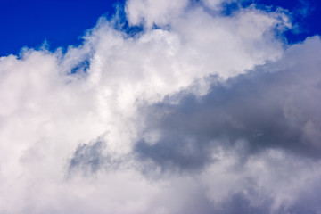 dense white clouds on a beautiful summer blue sky