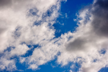 dense white clouds on a beautiful summer blue sky
