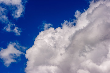 dense and great white clouds on a beautiful summer blue sky
