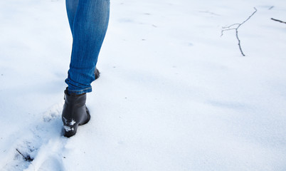 female feet leave footprints in the snow