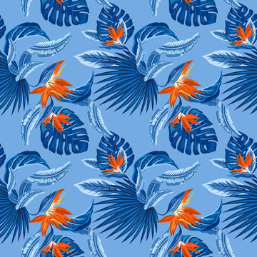 seamless pattern of tropical blue palm leaves, monstera  leaves  and coral flowers of the bird of paradise (Strelitzia) plumeria on a light blue background. Wallpaper trend design.