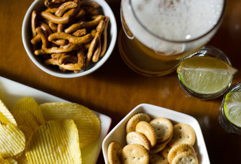 set of various snacks, pint of lager beer in a glass, a standard set of drinking and eating in a pub