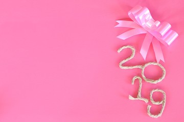 Happy New Year 2019 on pink wooden background