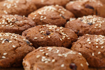 Pattern of oatmeal cookies with dried berries and sesame. Selective focus.