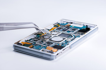 Repairing the smartphone's motherboard in the lab. the concept of computer hardware, mobile phone,...