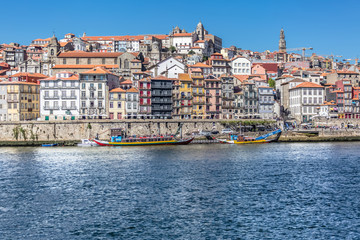Fototapeta na wymiar View of river Douro, with Rabelo boats on Ribeira docks, traditional downtown as background