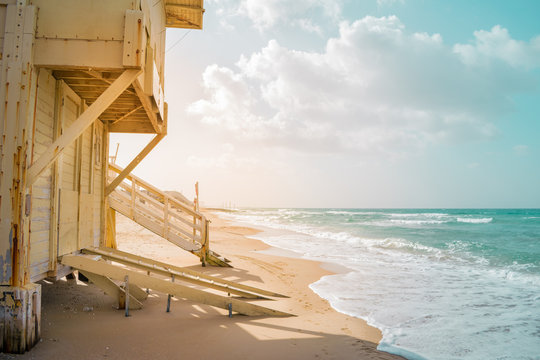 View of Tel Baruch Beach in Tel Aviv, Israel. Baywatch cabin against sunlight and mediterranean horizon.
