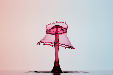 abstract waterdrop collision sculpture in red and pink color