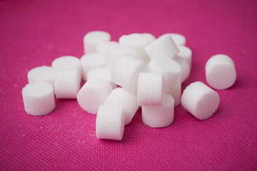 closeup of sugar in shaped circle on pink background