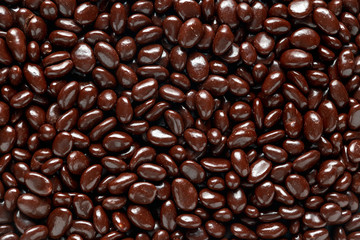 chocolate beans with raisin close up, background, texture.