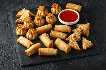 Crispy Chicken wontons, vegetable spring rolls and prawn toasts with sweet chilli sauce. chinese selection. fast food.