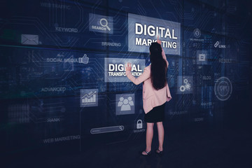Businesswoman presses digital marketing button