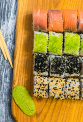 Still life with raw food sushi on the wooden background