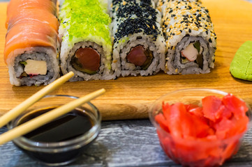 Still life with raw food sushi on the wooden background