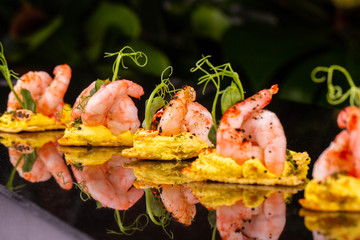 Shrimps with greens and seasonings on the crackling bread