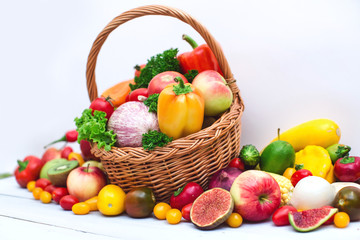 Naklejka na ściany i meble Fresh vegetables and fruit in basket isolated on white.