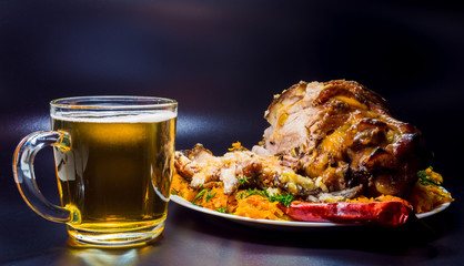fresh baked pork knuckle. Food on a dark background