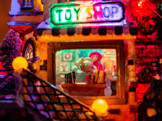 Tiny people walking in the city at night, Christmas village macro, holidays, closeup, festive, toy houses, model city, happy holidays.