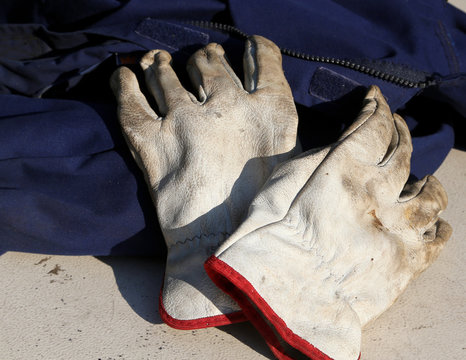 work gloves over a worker overalls