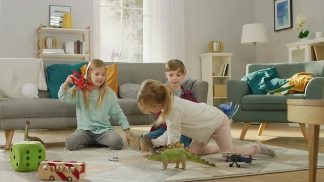 In the Living Room: Boy and Girl Playing with Toy Airplanes and Dinosaurs while Sitting on a Carpet. Sunny Living Room with Children Having Fun.