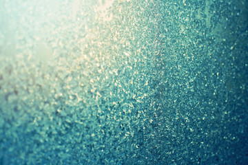 Winter blue background of snowflakes and frost