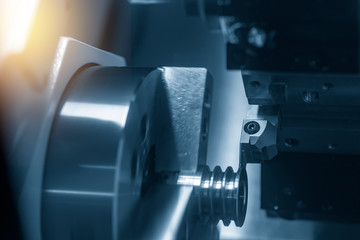 The CNC lathe or turning machine cutting  the slot  at the metal part.Hi-technology manufacturing...
