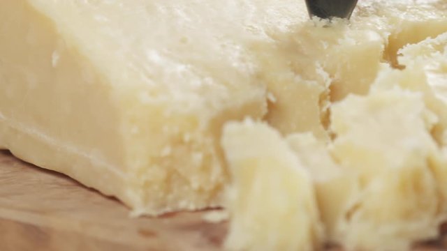 slide pieces of hard parmesan cheese on olive board