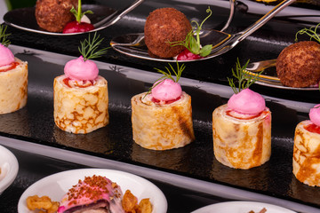 Portion pancakes fish and greens