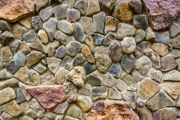 Wall of multi-colored stones