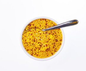 Mustard sauce, wholegrain mustard in bowl isolated on white background. Top view