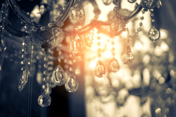 abstract image background of blur bokeh and crystal chandelier light equipment filter tone color effect