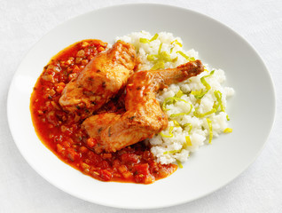 stewed in vegetables rabbit legs garnished with rice and leek