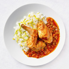 braised rabbit legs stewed with vegetables garnished with rice with leek
