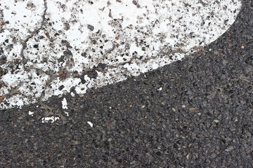 Asphalt pavement sign marking crosswalk white paint wet old surface texture detail