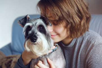 portrait of pretty girl and her cute schnauzer dog
