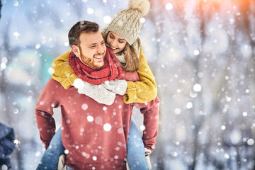 Happy Young Couple in Winter Park laughing and having fun. Family Outdoors. - 240259974