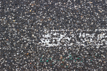 Asphalt pavement sign marking crosswalk white paint wet old surface texture detail