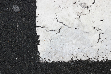 Obraz premium Asphalt pavement sign marking crosswalk white paint wet old surface texture detail