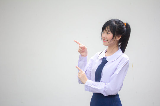 Portrait Of Thai High School Student Uniform Beautiful Girl Pointing