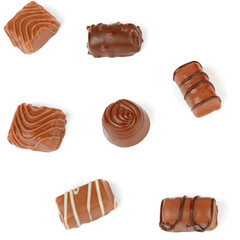 Assortment of chocolate candies isolated on white background.
