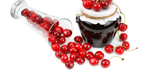 Cherries and jars of jam isolated on a white. Wide photo.