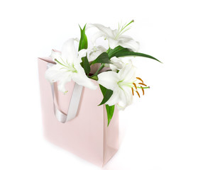 white lilies in a pink shopping bag © zyryanova
