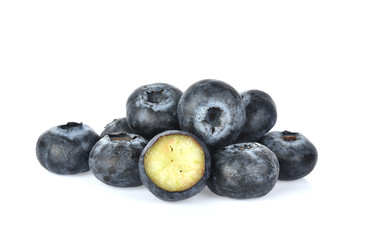Blueberries with green leaves closeup, isolated on white background