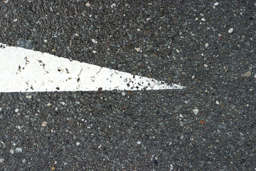 Fototapeta premium Asphalt pavement sign marking crosswalk white paint wet old surface texture detail