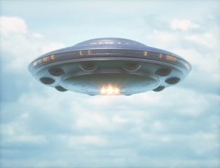 Unidentified flying object in cloudy sky with strong lights pointed towards the camera. © ktsdesign
